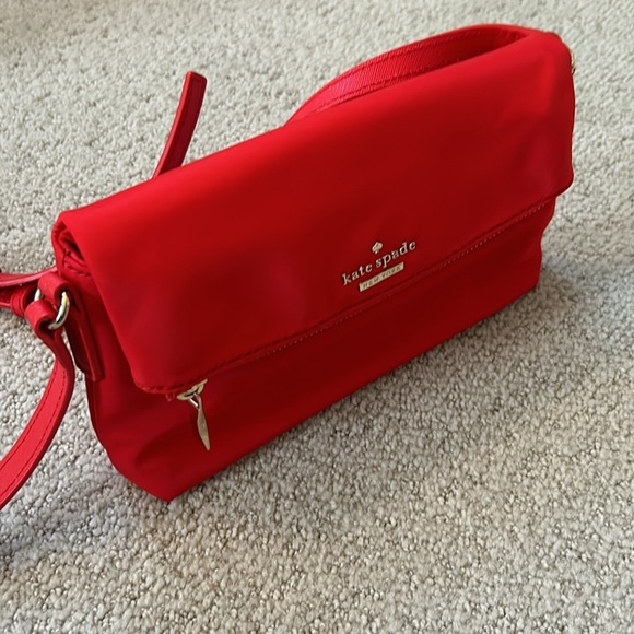 Kate Spade Red cross body purse. Fold over flap style. Zip pocket on front. - Picture 10 of 14